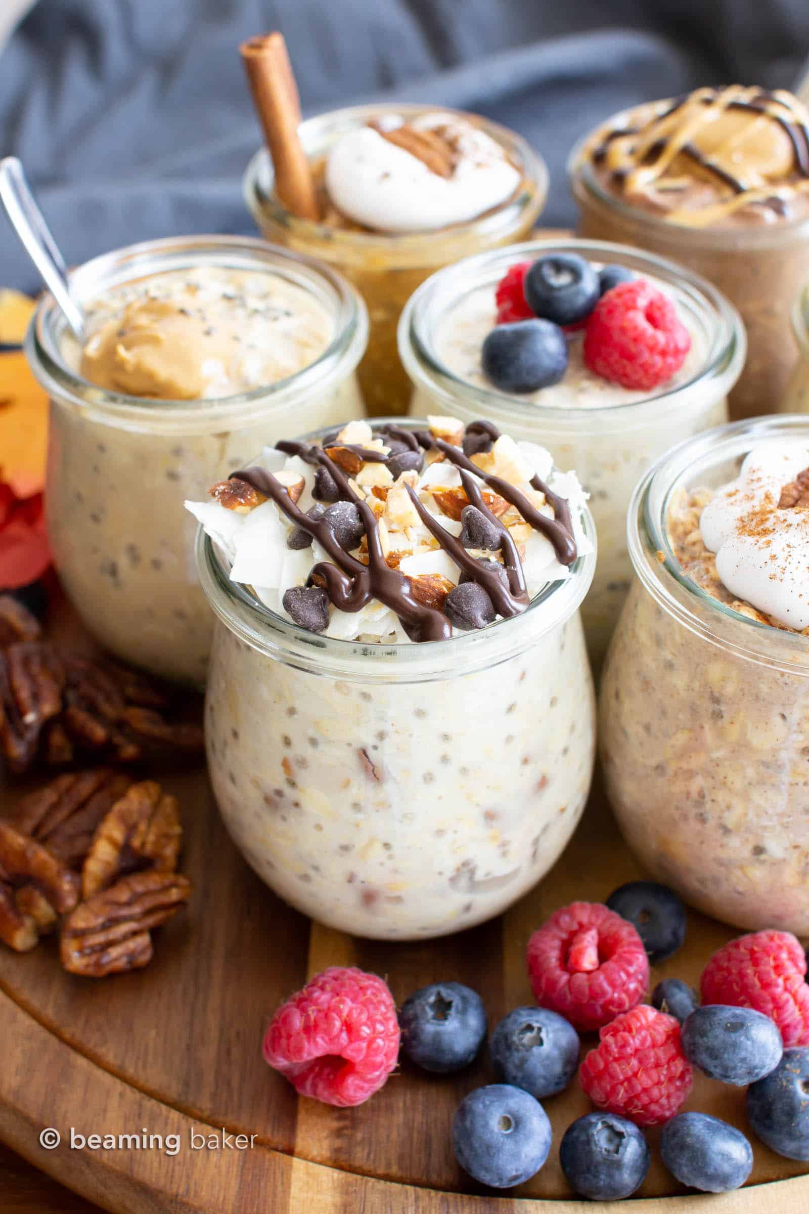 Almond joy overnight oats surrounded by more jars of vegan overnight oats and fruit