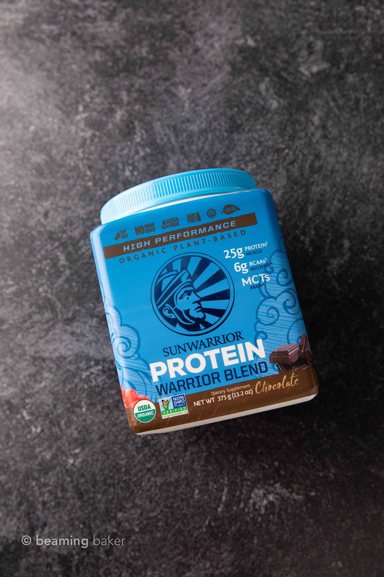 Container of Sunwarrior vegan chocolate protein powder on grey background
