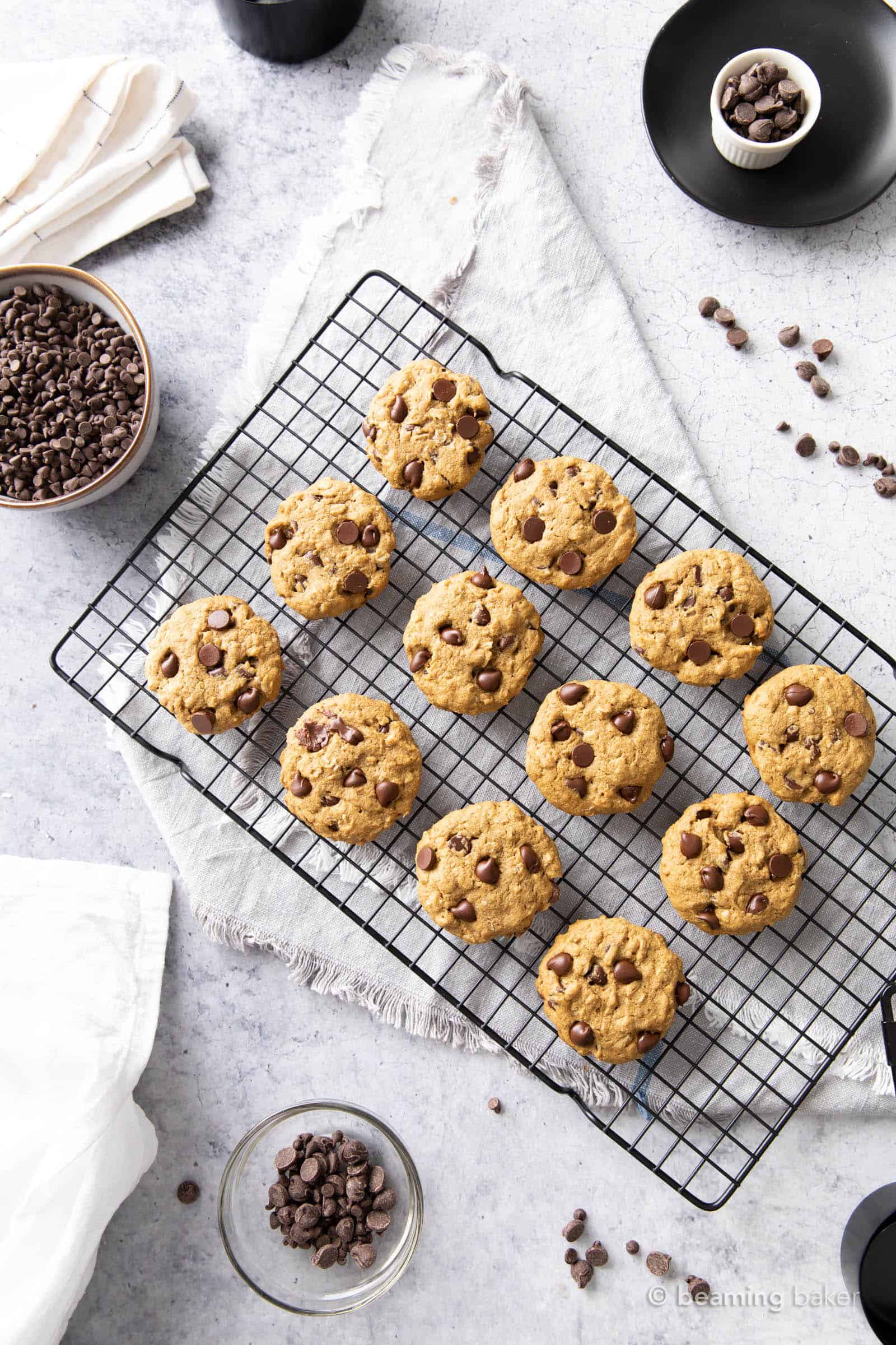 fresh baked oat flour cookies with chocolate chips in bowls and kitchen towels