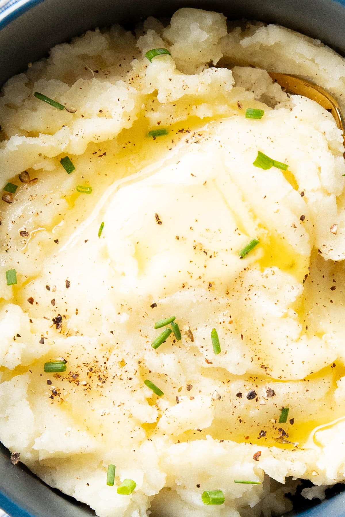 close up of mashed potatoes coated in melted butter, a vegetable side dish recipe